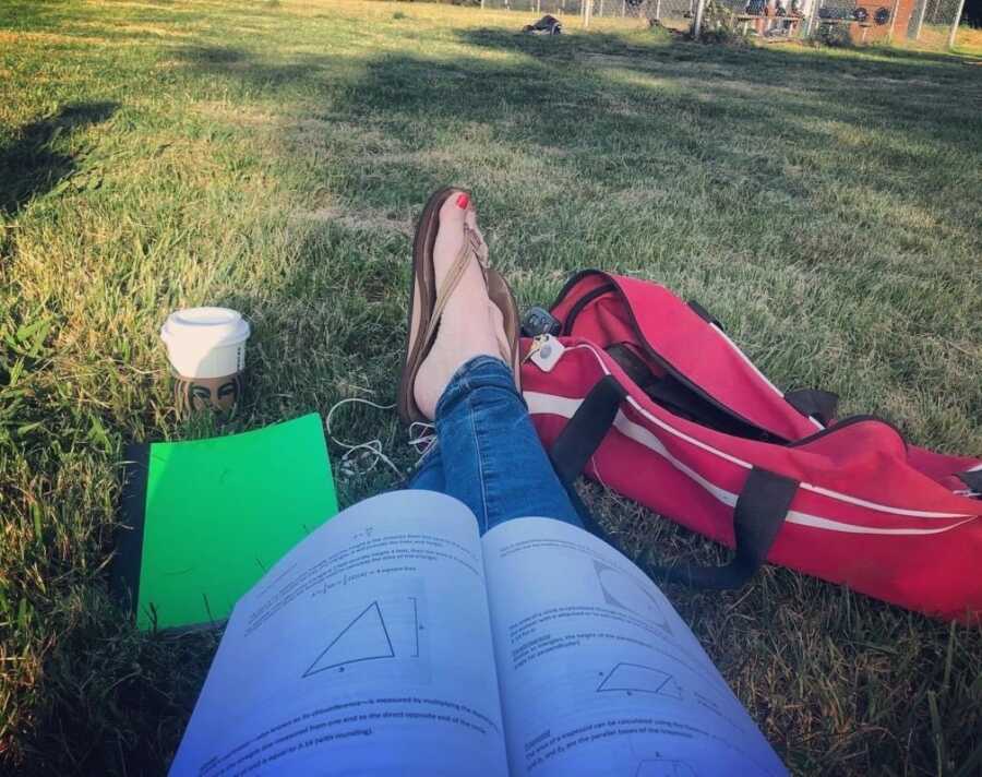 woman sitting outside and studying