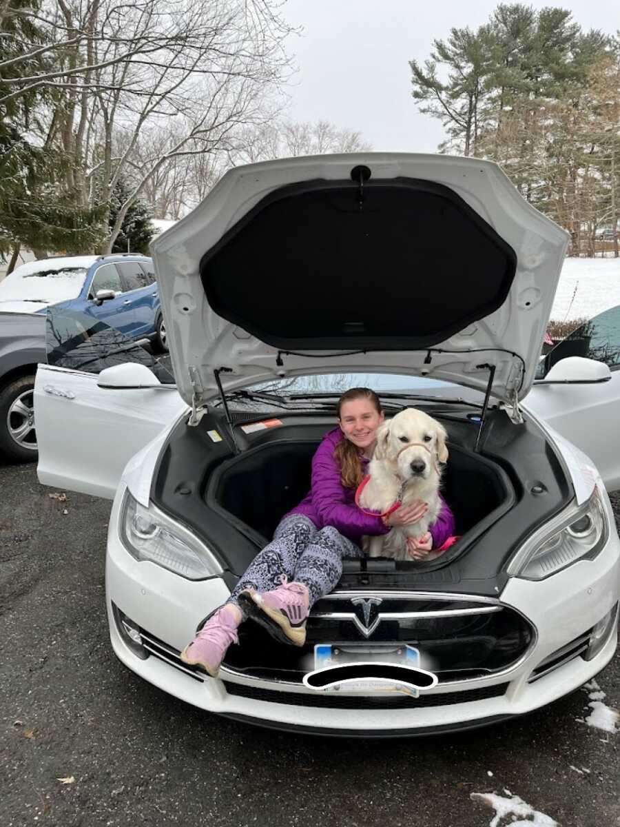 dog sitting in the trunk