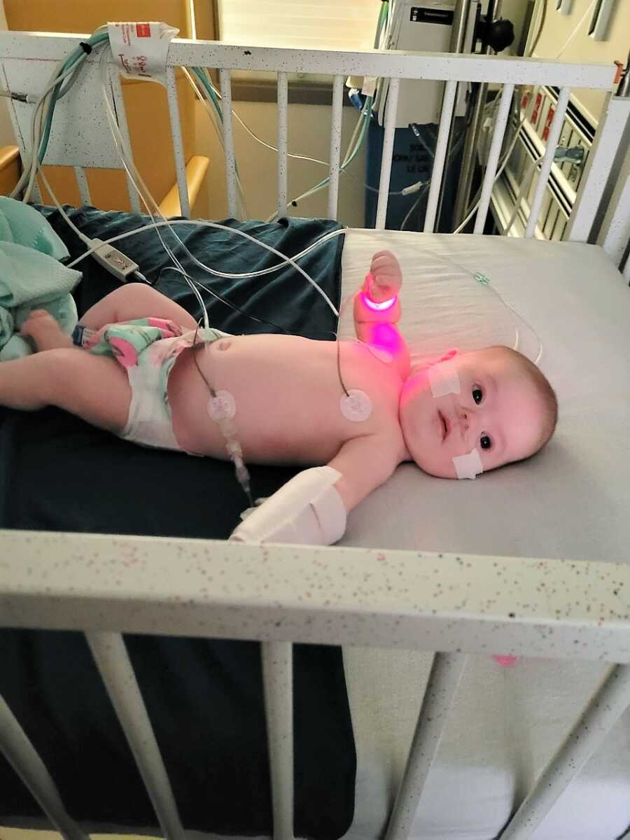 Rainbow baby with Down Syndrome on a crib at NICU due to heart problems
