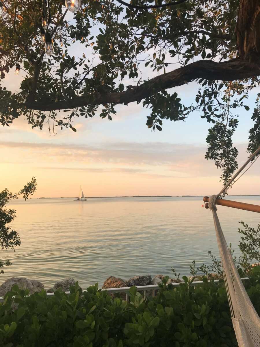 woman sitting on a hammock on the beach