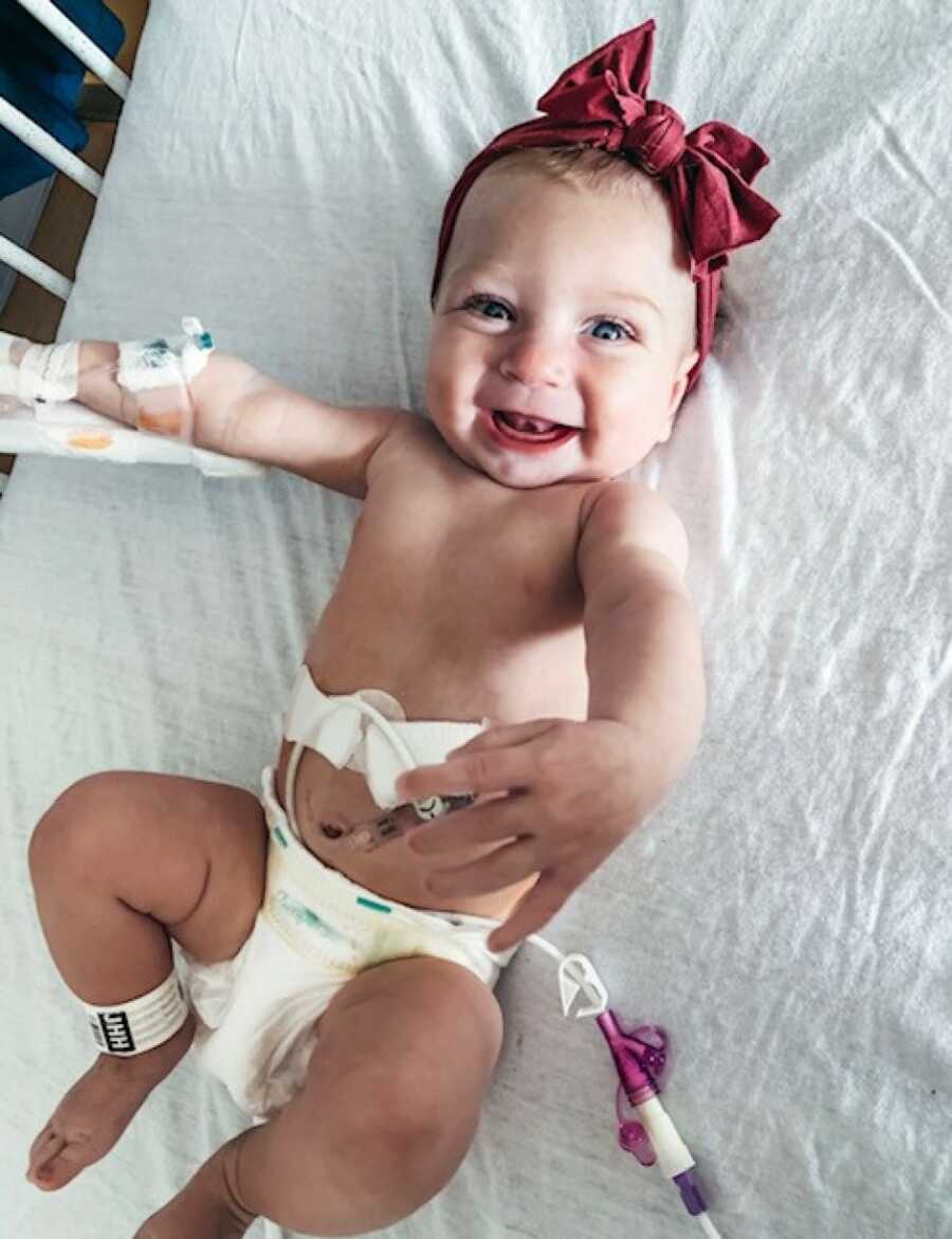 little girl smiling with her feeding tube