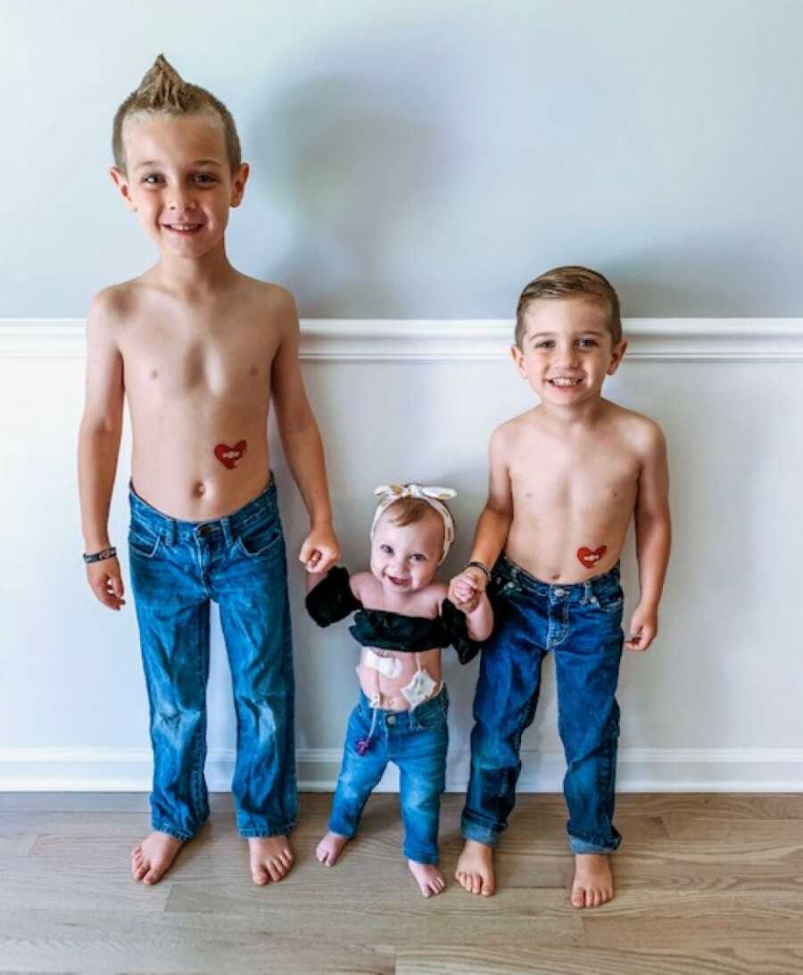 little girl with her brothers smiling
