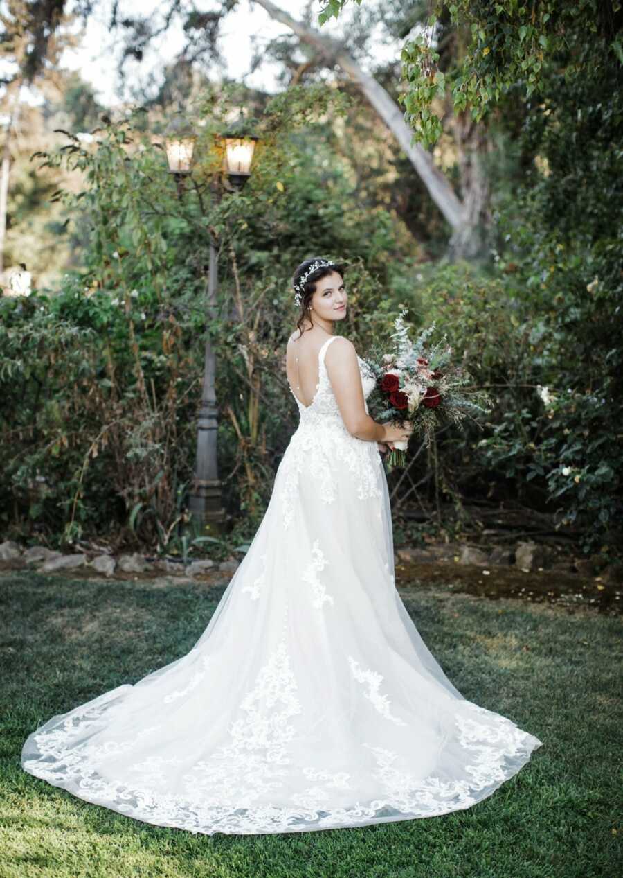 woman in her wedding dress posing