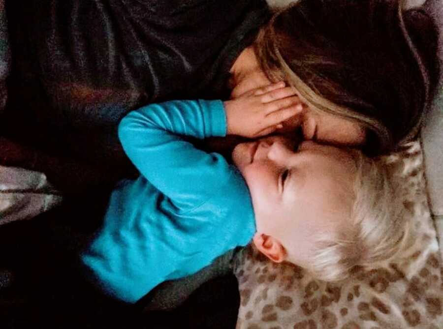 Mom snaps sweet photo of her cuddling her young son at night