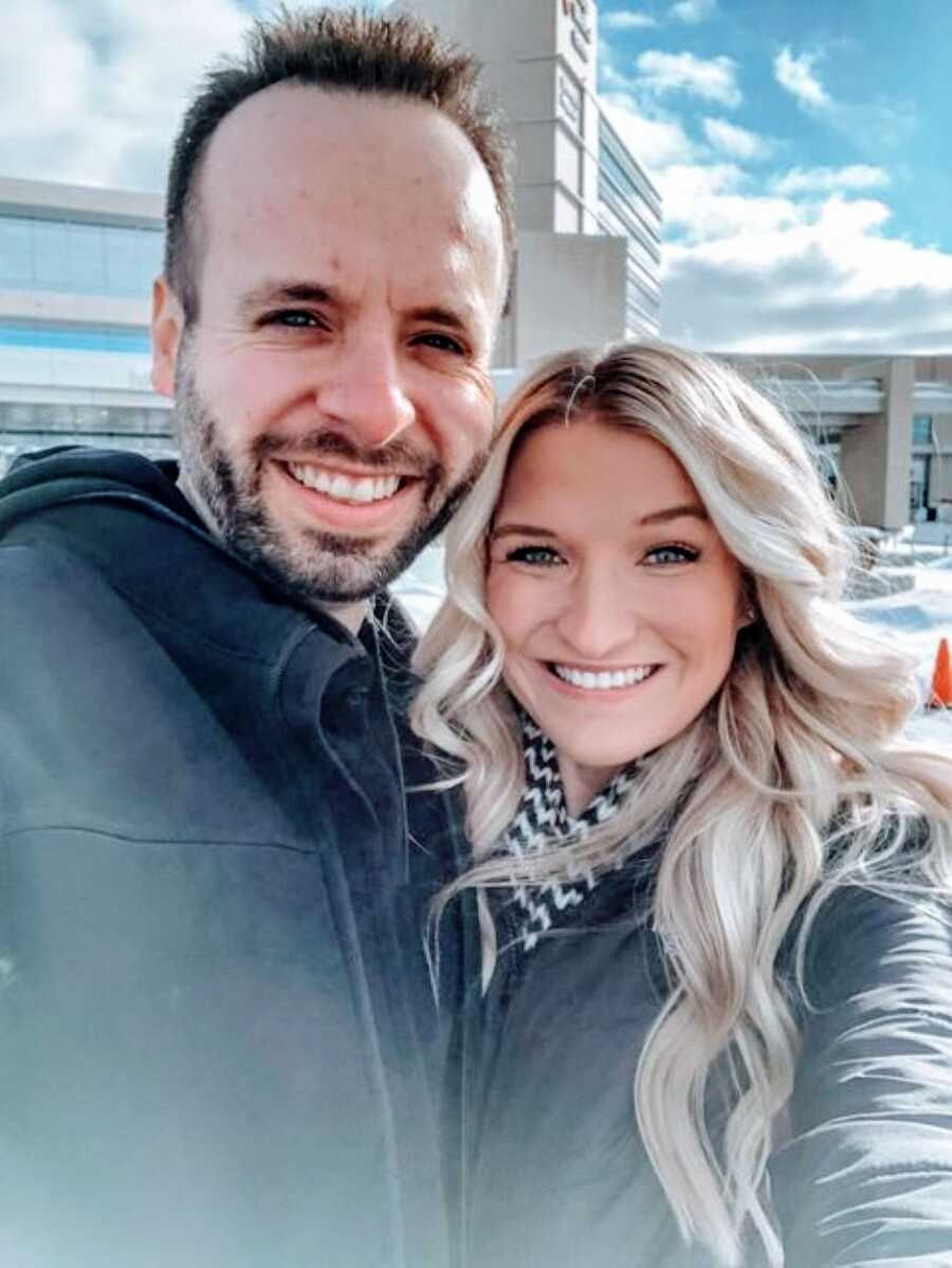 Coupe battling infertility take a selfie in a parking lot