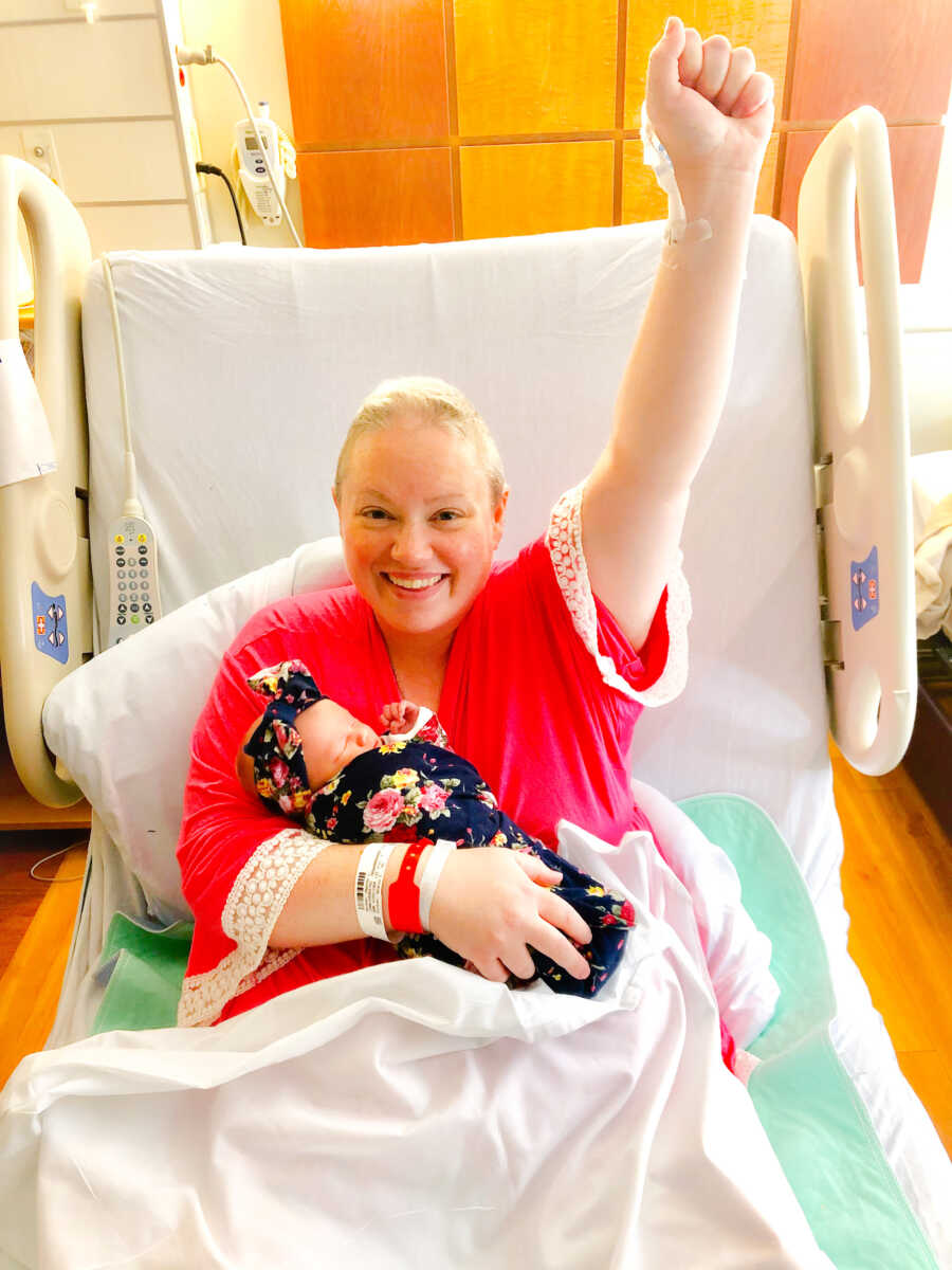 woman in bed with her child and fighting cancer