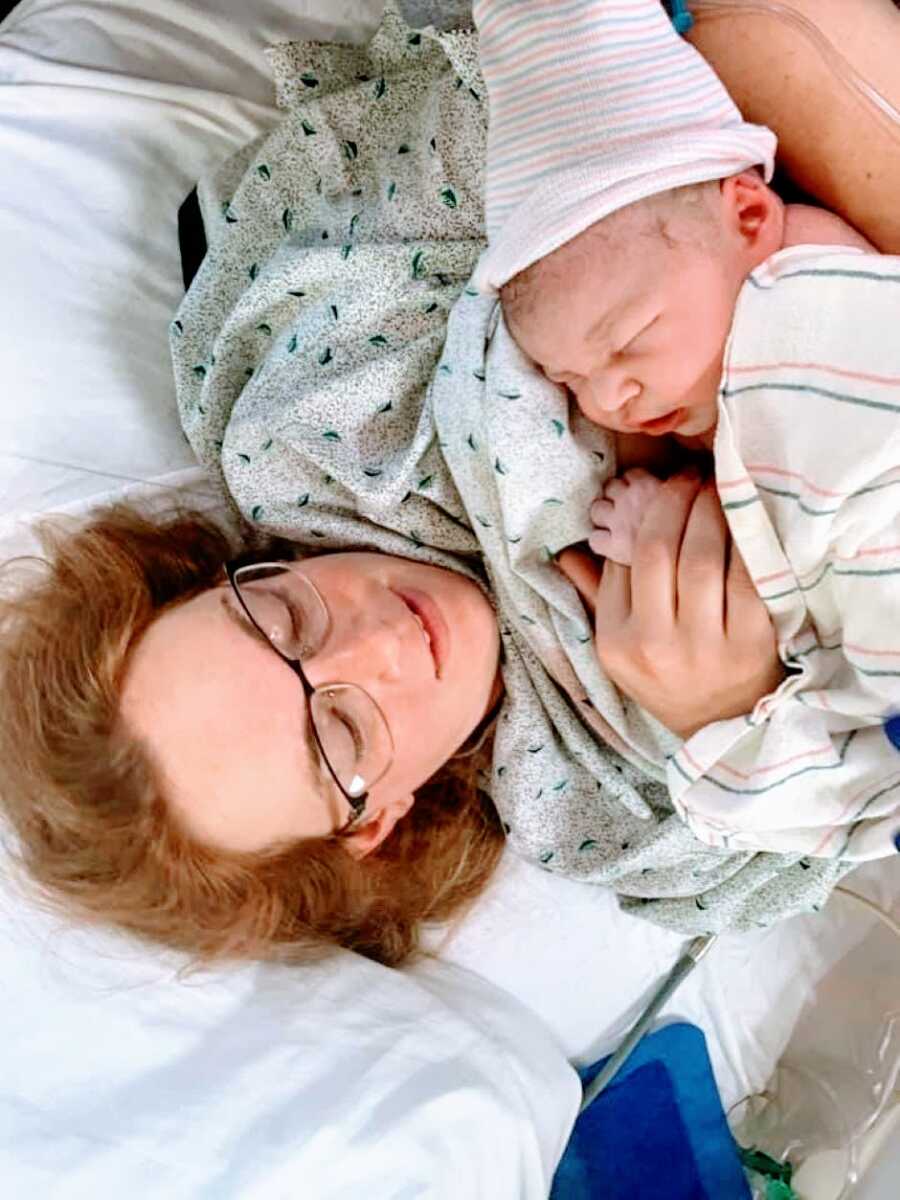 Mom holds her newborn son in the hospital after giving birth to him