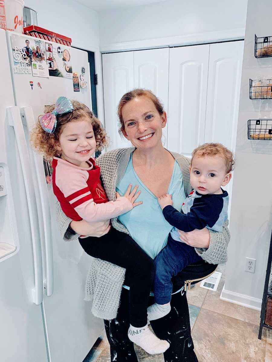 Mom holds her two children conceived through embryo adoption