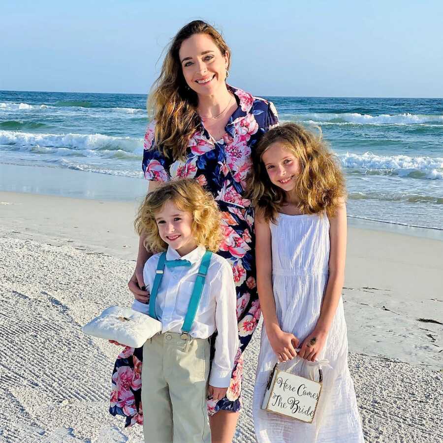 lesbian mom and her two children at at a wedding at the beach