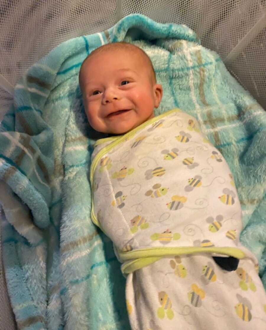 new born son smiling