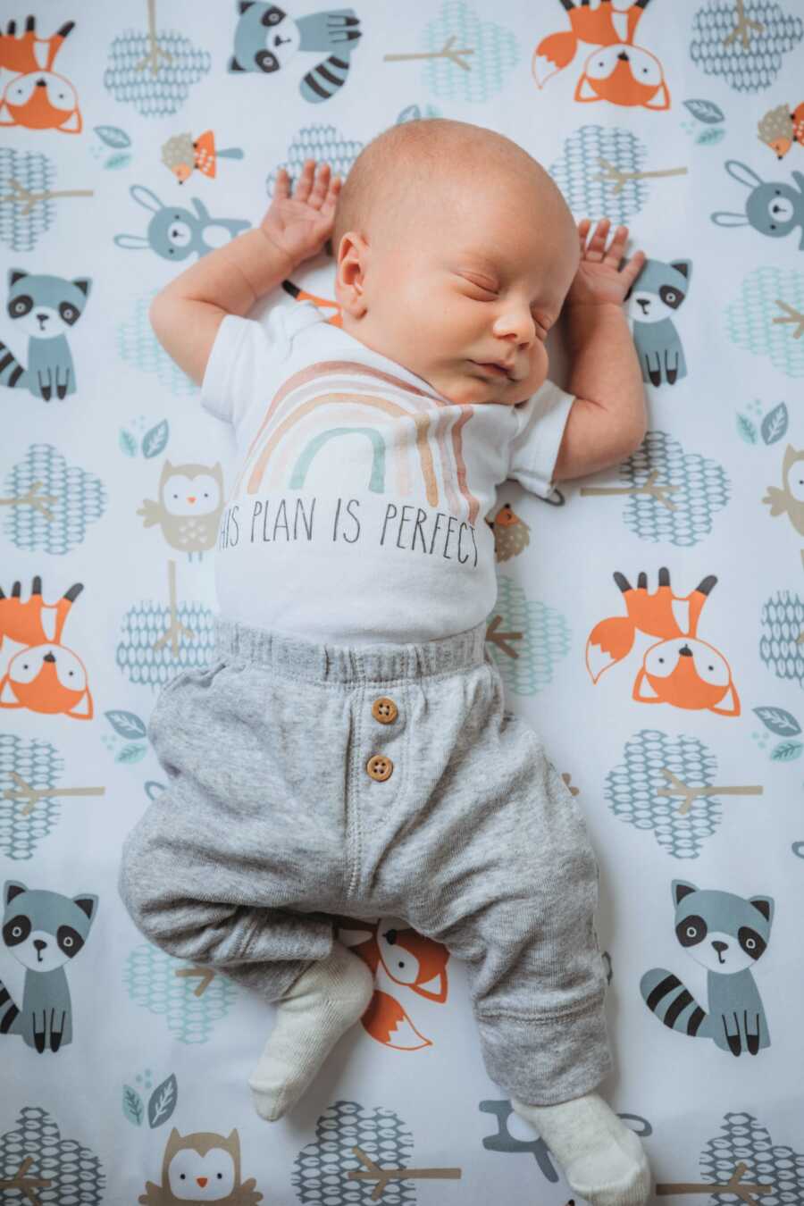 newborn rainbow baby wearing a rainbow shirt that says HIS PLAN IS PERFECT