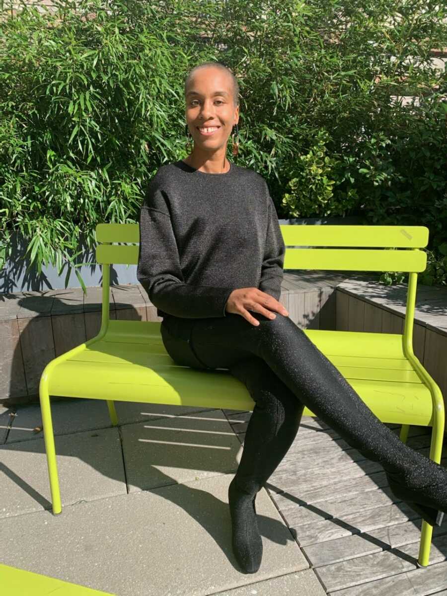 woman sitting on a bench smiling