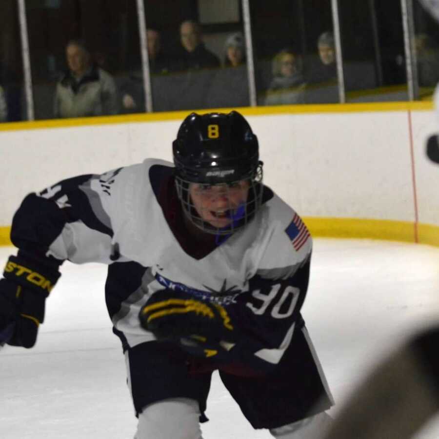 girl playing hockey racing for the puck