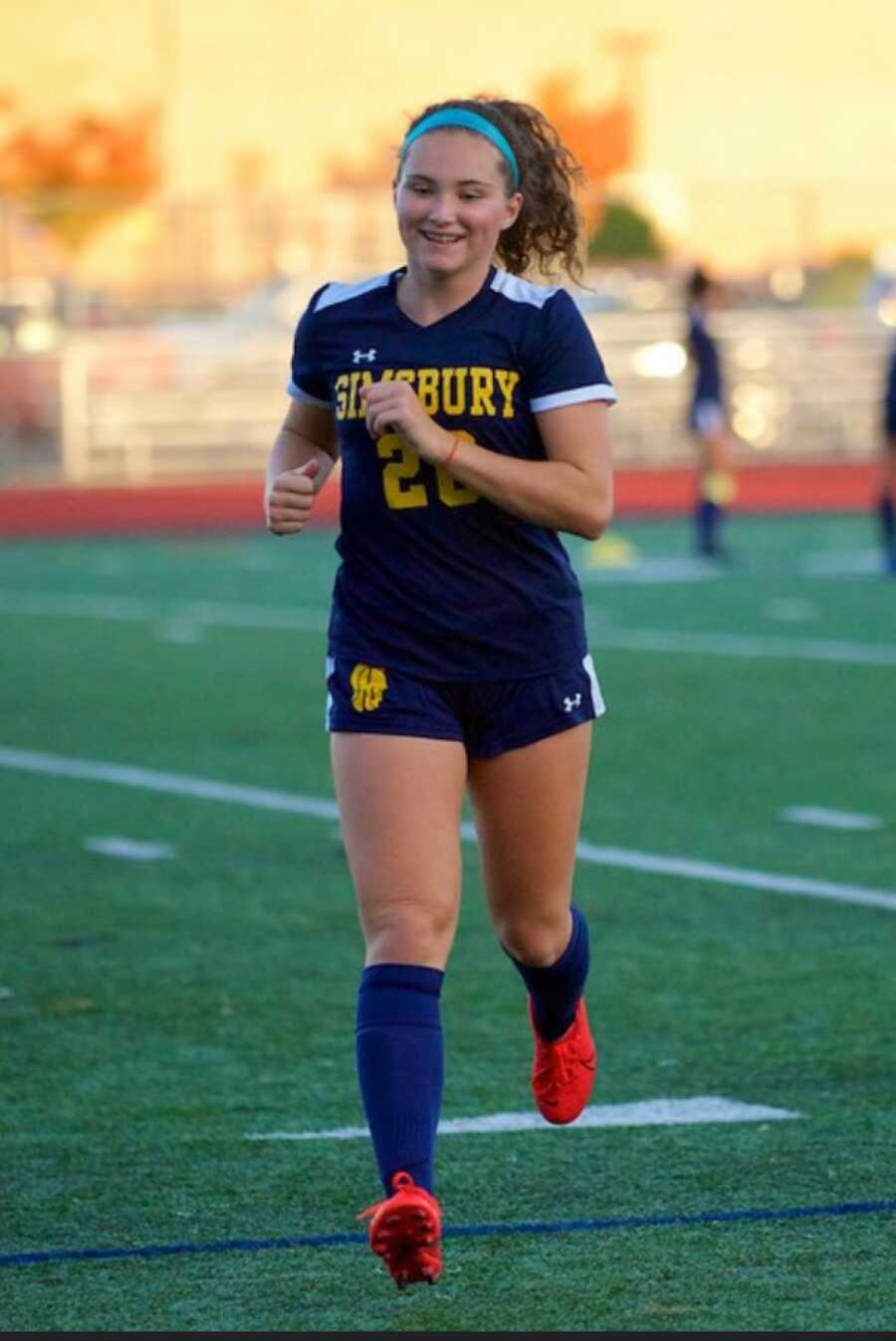 girl running on the soccer field