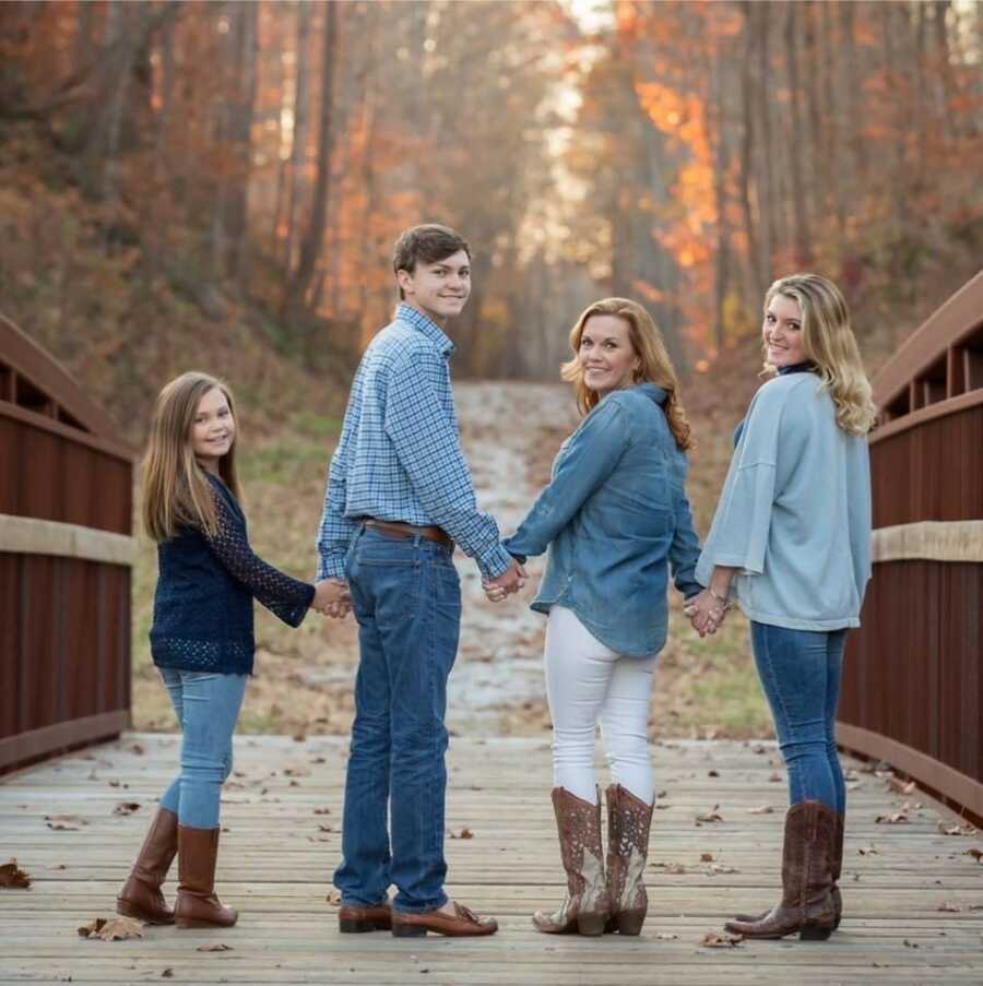 mom and her kids walking in a forest