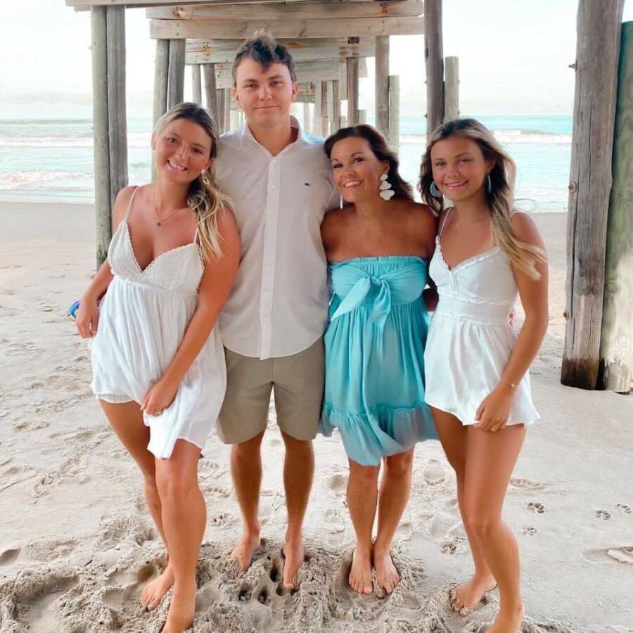 family at a beach taking a pic