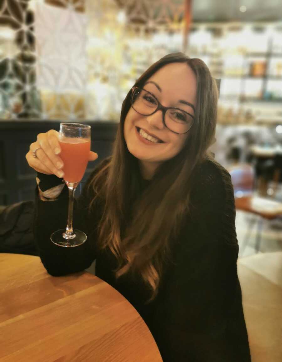 woman taking a selfie with a drink