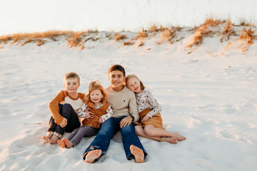 four kids on a beach