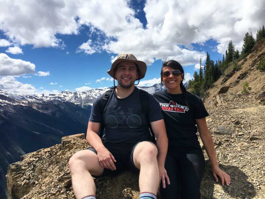 woman and her husband in the mountains taking a picture