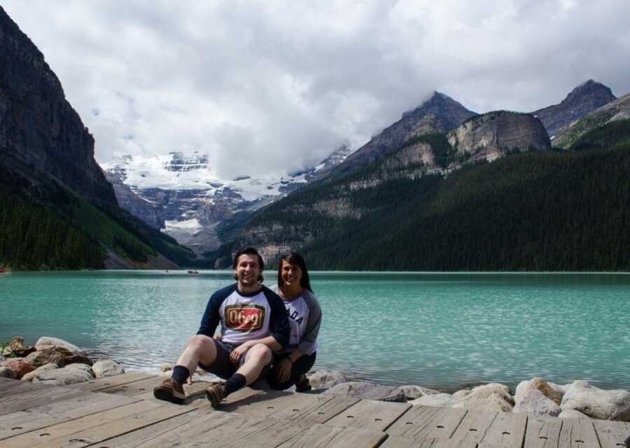 woman and husband by a lake taking a picture