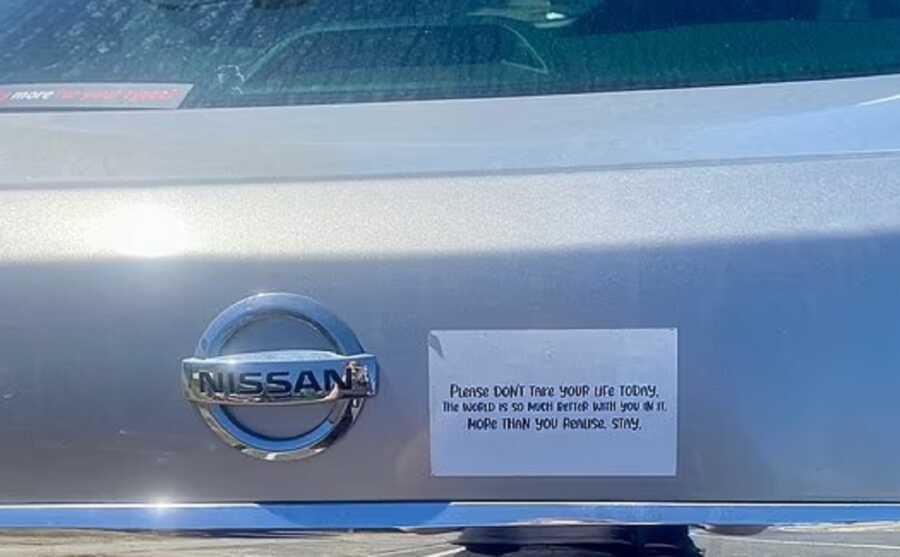 University student's homemade bumper sticker placed on the back of her car.