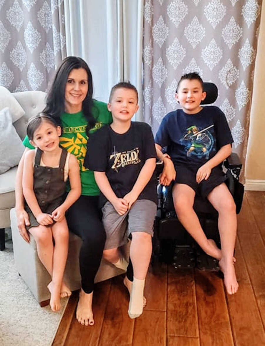 mom poses with her three children; a daughter and two sons who have Duchenne's