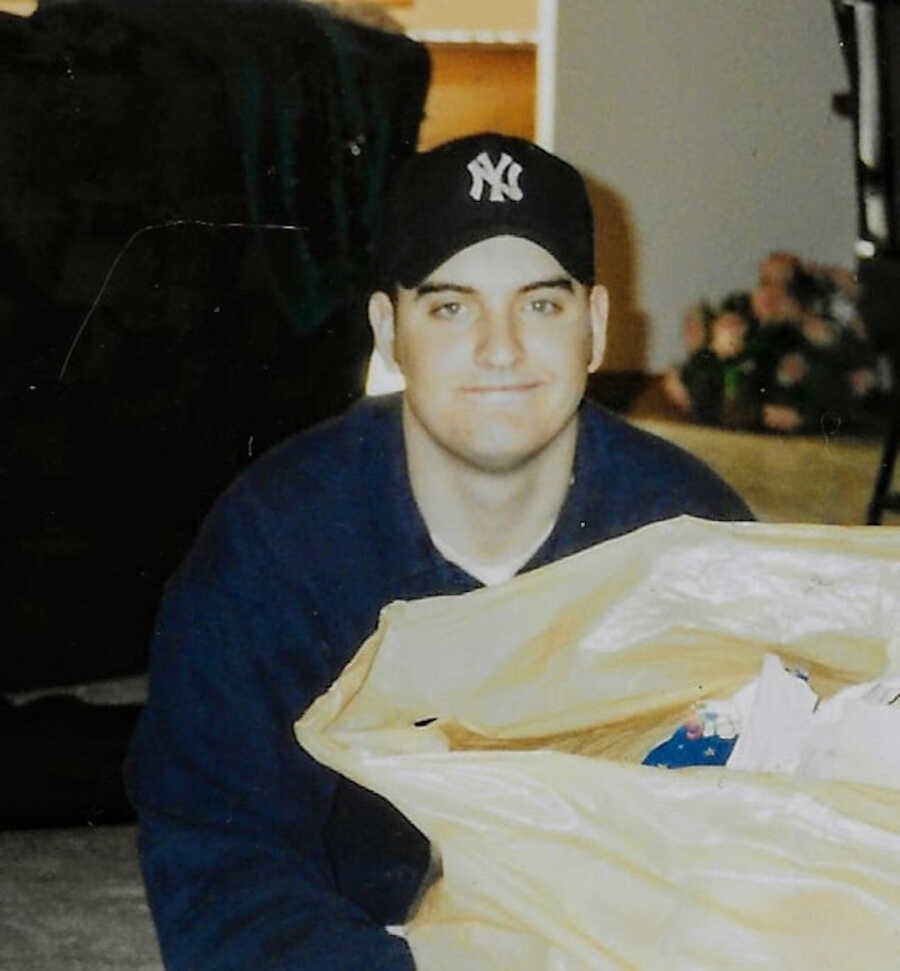 old image of brother who has passed wearing a yankees hat with a smug smile