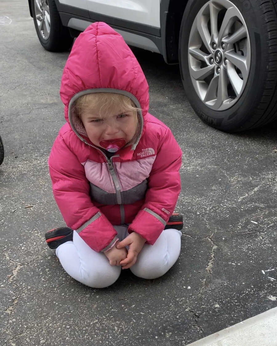 little girl on the ground upset