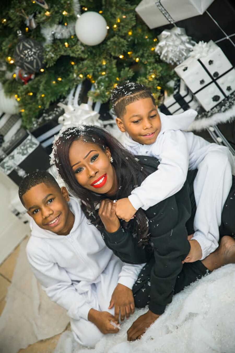 Single mom and sons take family Christmas picture together.