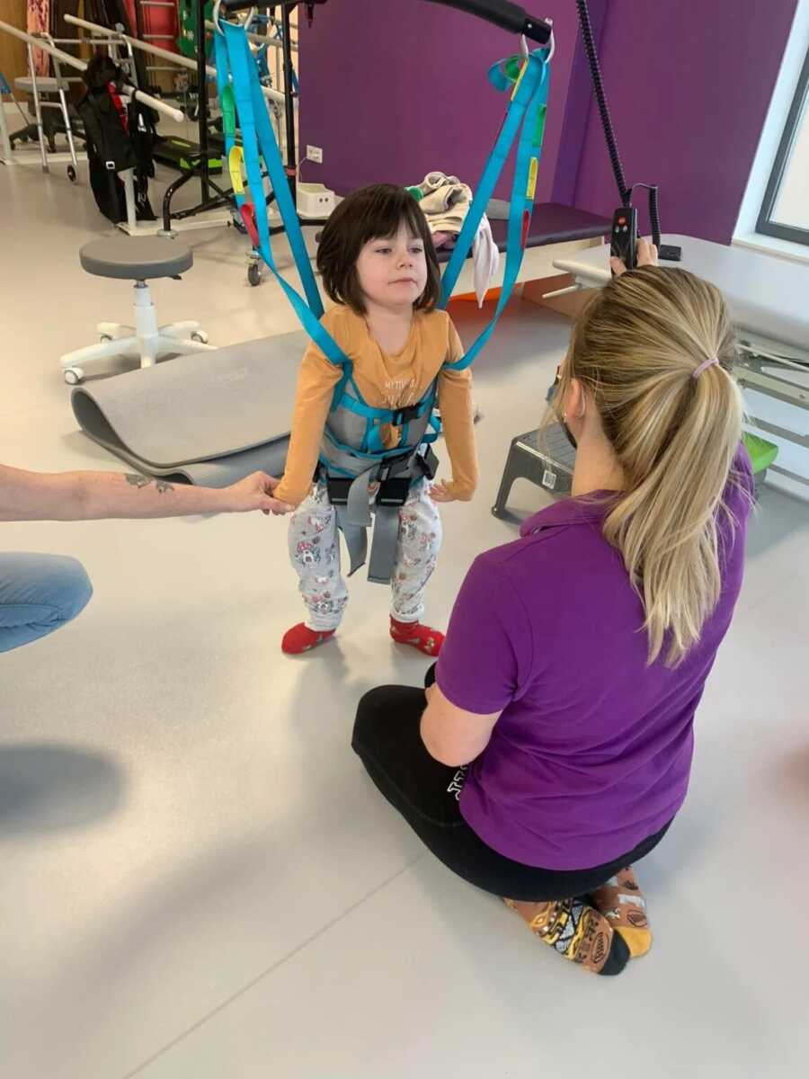little girl doing rehab with a pt