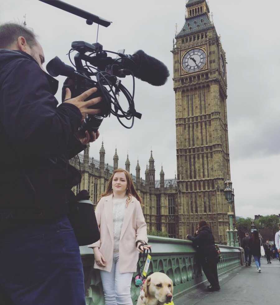 woman doing an interview with her guide dog