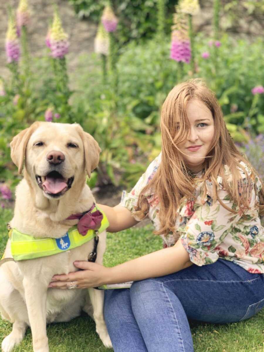 woman and guide dog in the grass