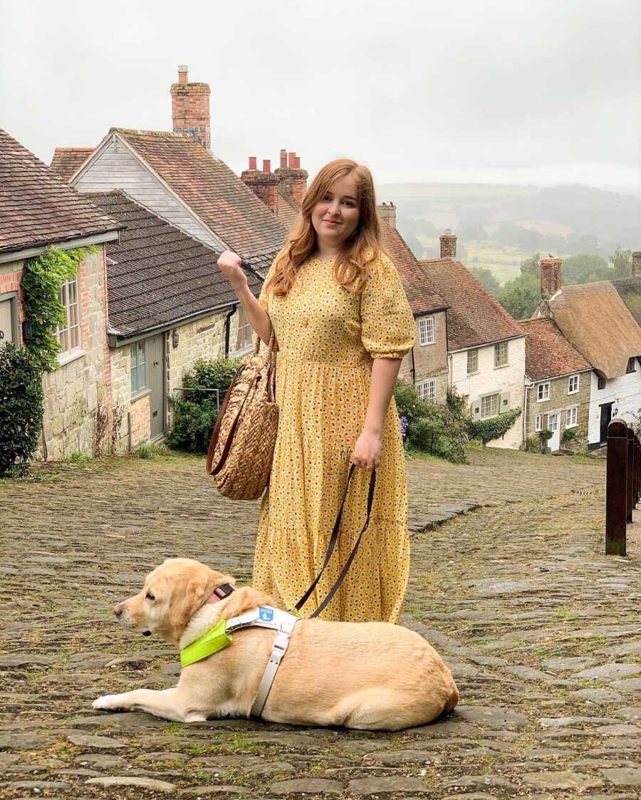 woman smiling at her guide dog