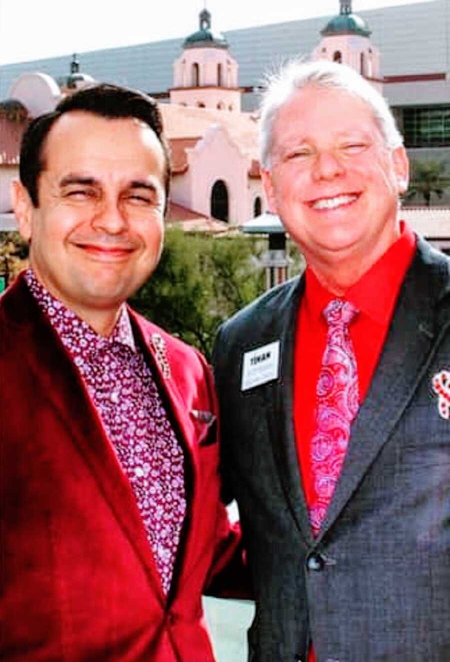 A former inmate stands with another man, both in suits