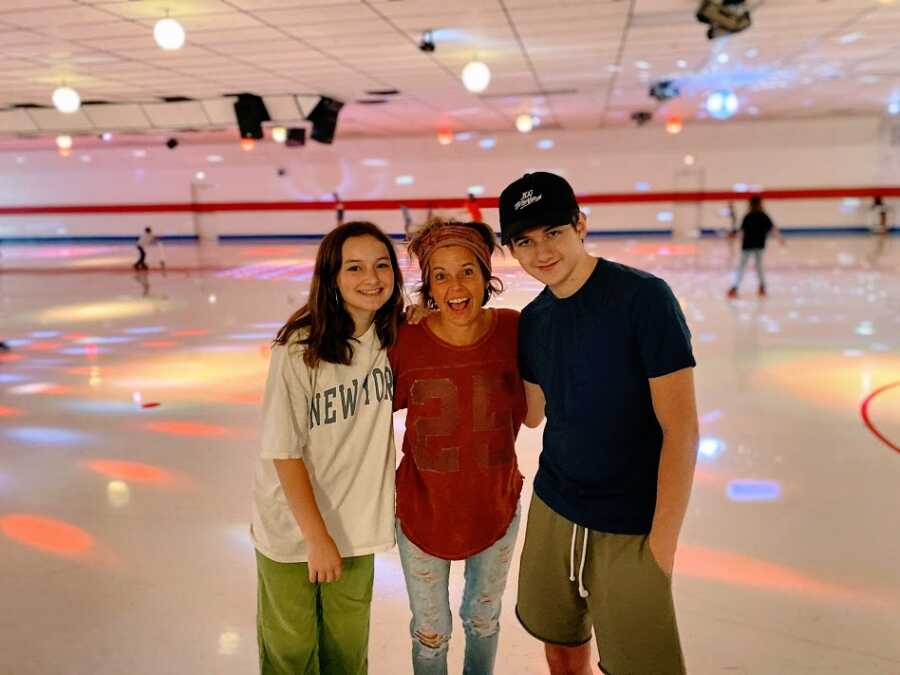 A mom with her teenagers at a skating rink