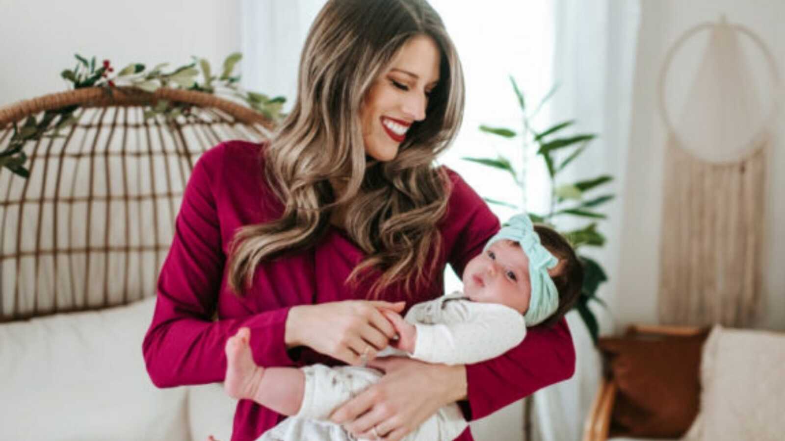 woman holding her child and smiling down at them