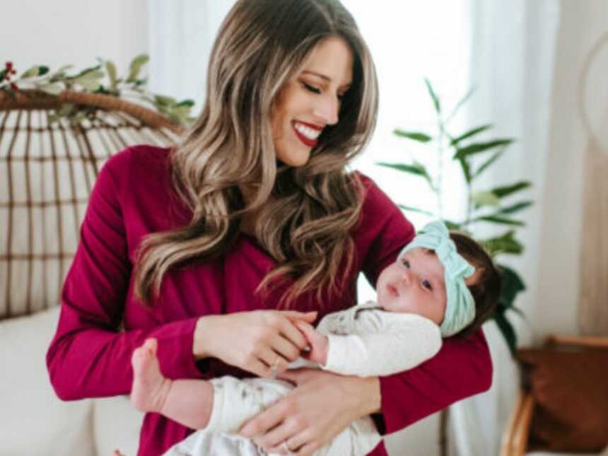 woman holding her child and smiling down at them