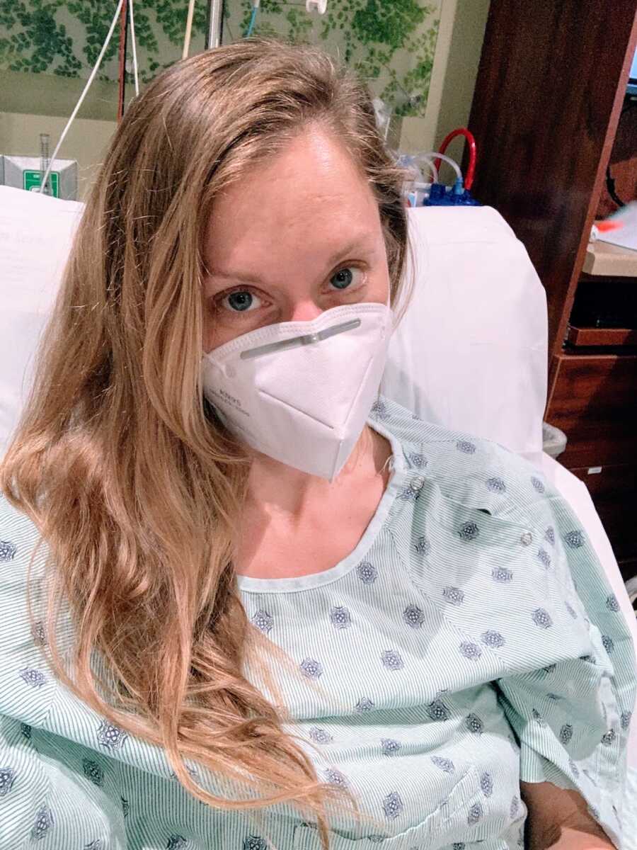 woman sits in a hospital bed pre-op before surgery on her brain