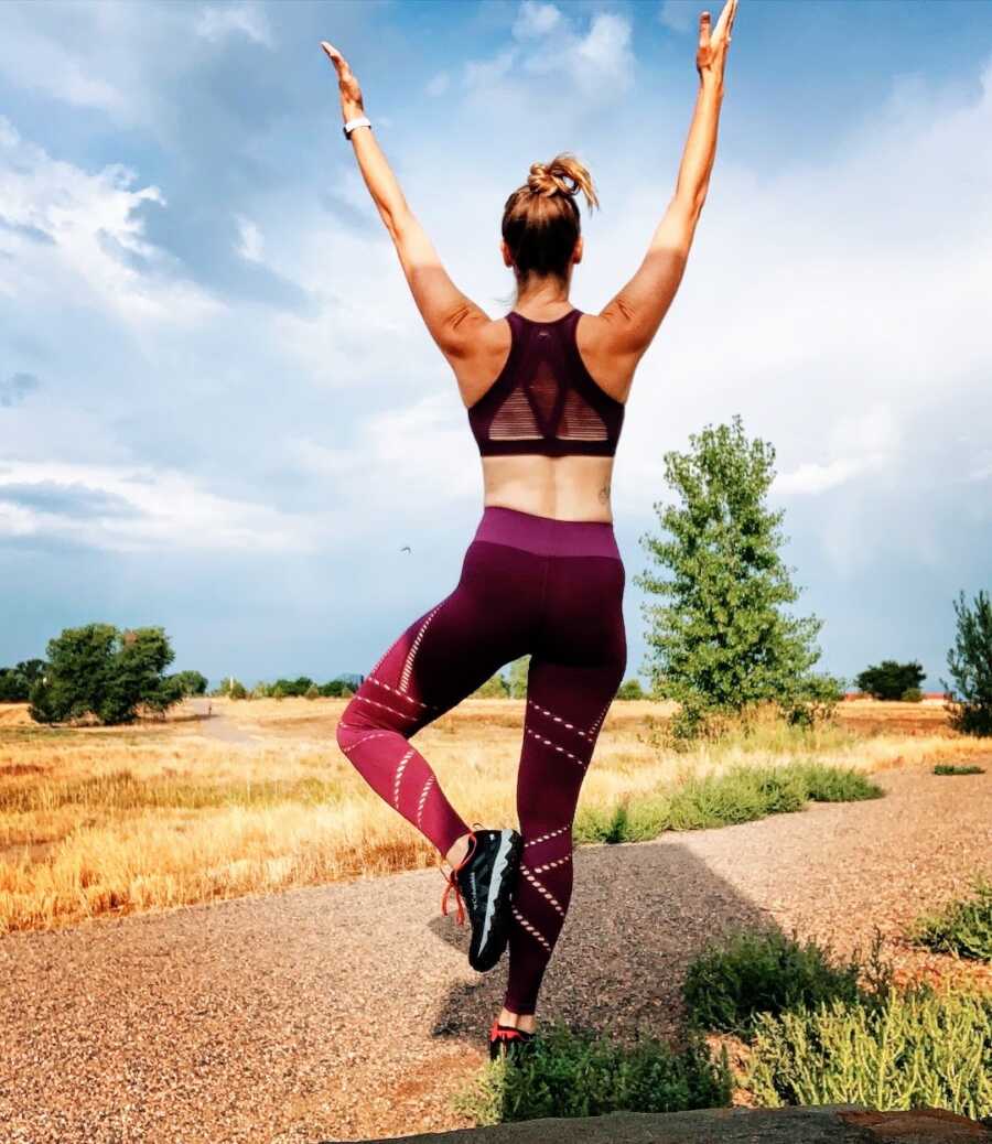 divorced woman does yoga while outside in colorado