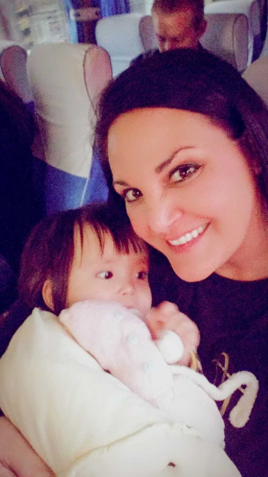 mom takes selfie with internationally adopted daughter while on a plane