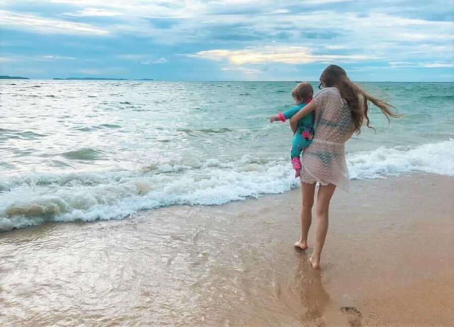 mom and her baby on the beach