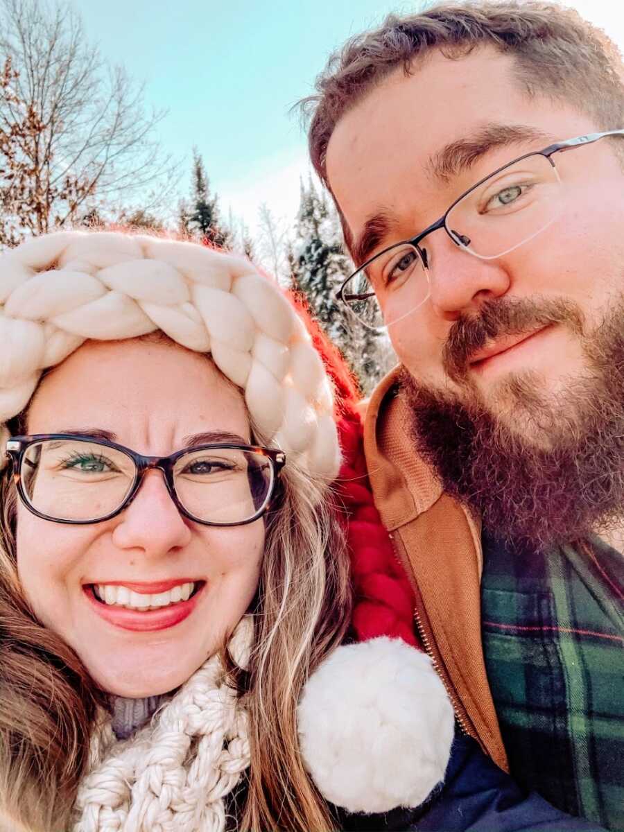 Couple take up-close selfie with each other during a winter walk