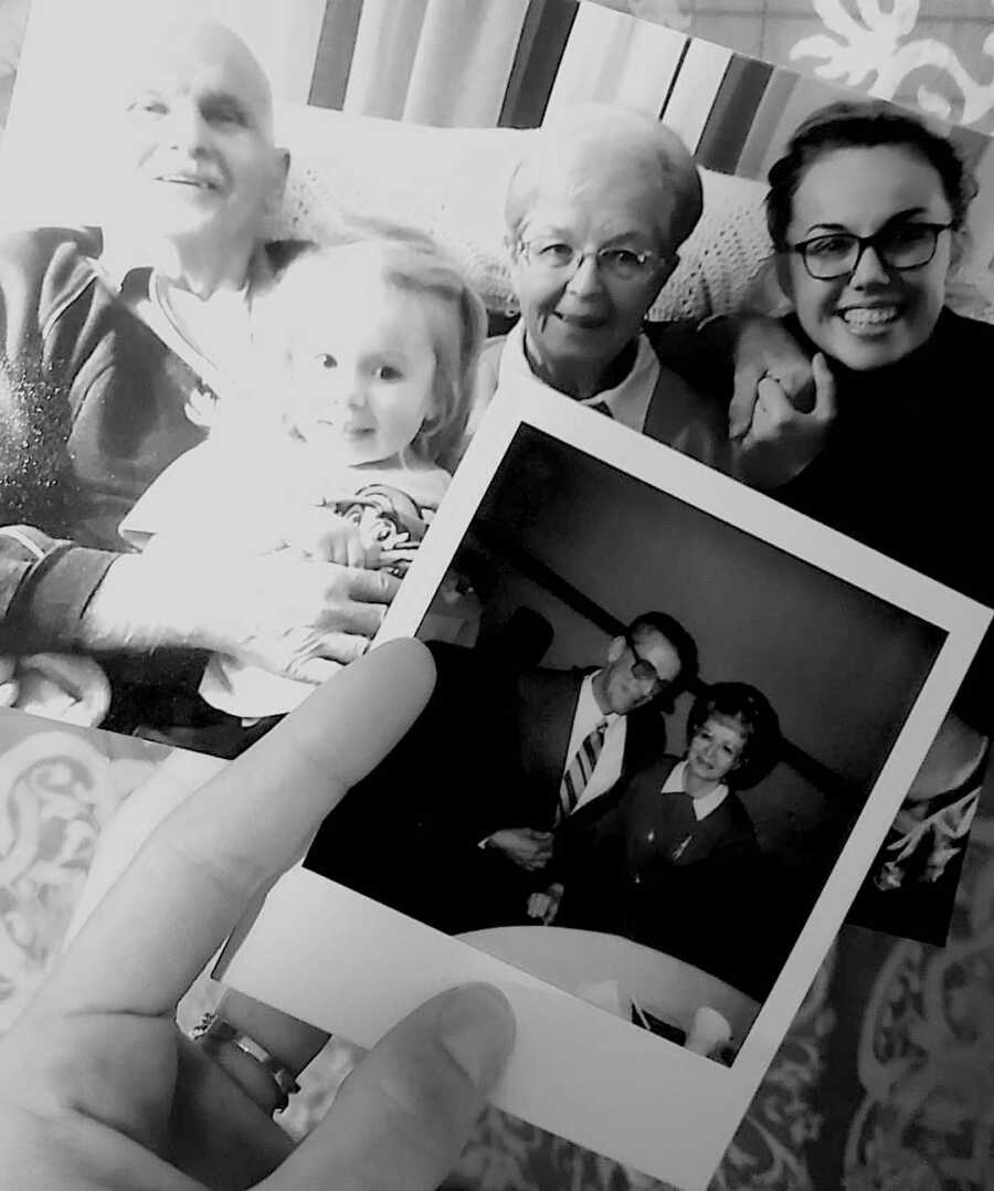 grandparents and granddaughters sit together in front of a polaroid of the young grandparents