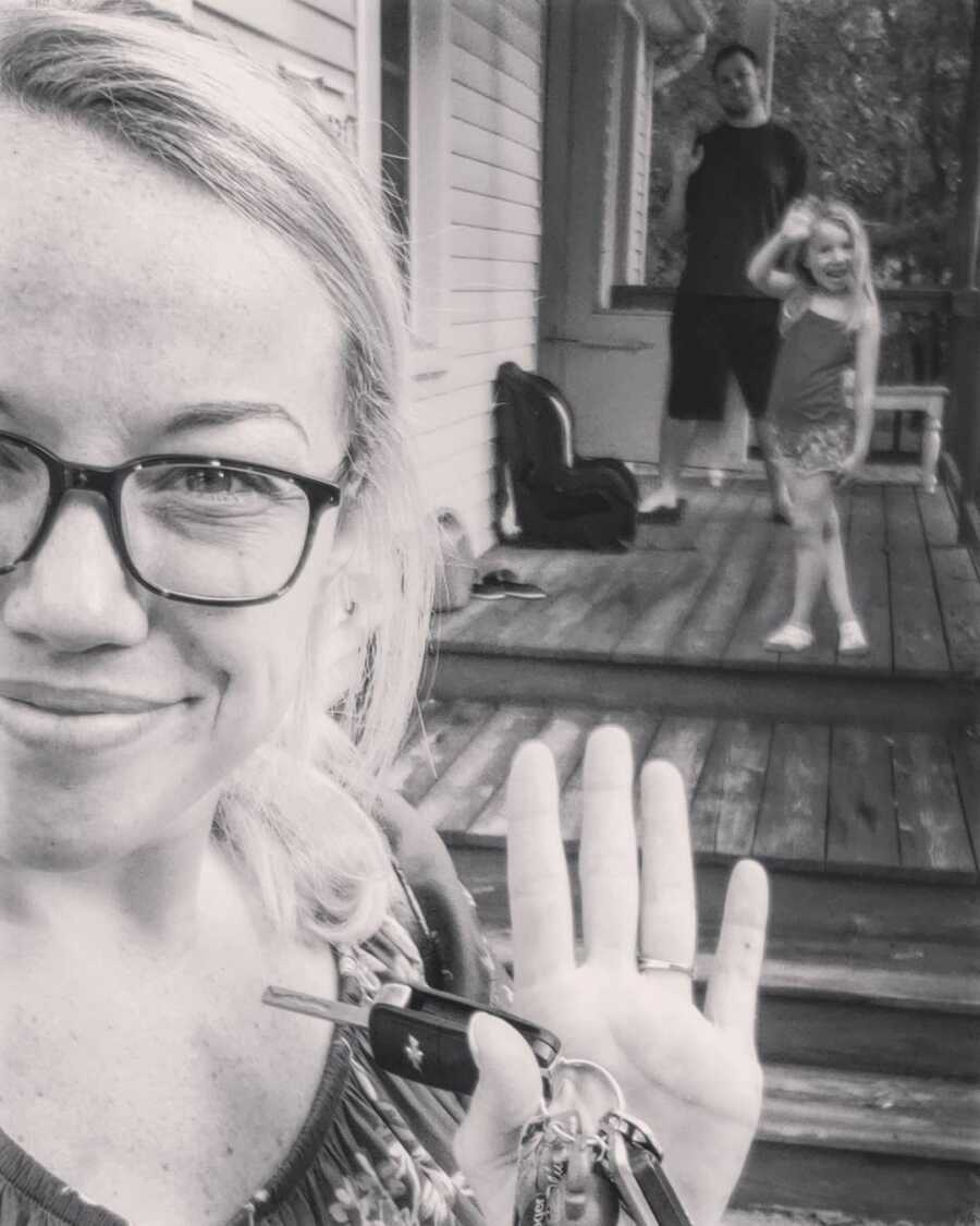 mom waves bye to her child behind her to return back to work