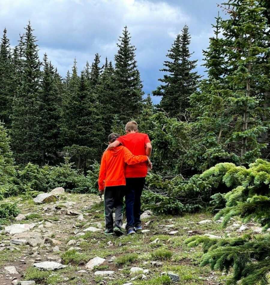two brothers out in the forest hiking together