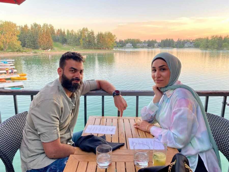 woman and her husband taking a picture together at a restaurant 