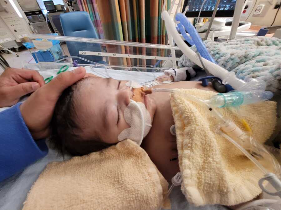 little boy in nicu being comforted