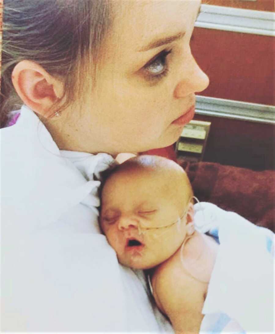 First time mom holding newborn son with down syndrome on her chest 