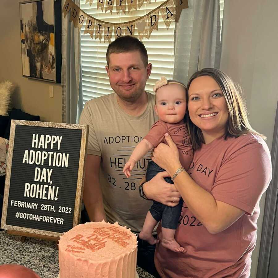 mom and dad with daughter happy