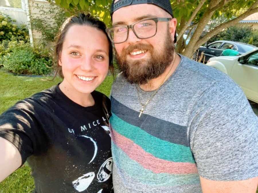 Couple take selfie together in front a big plant